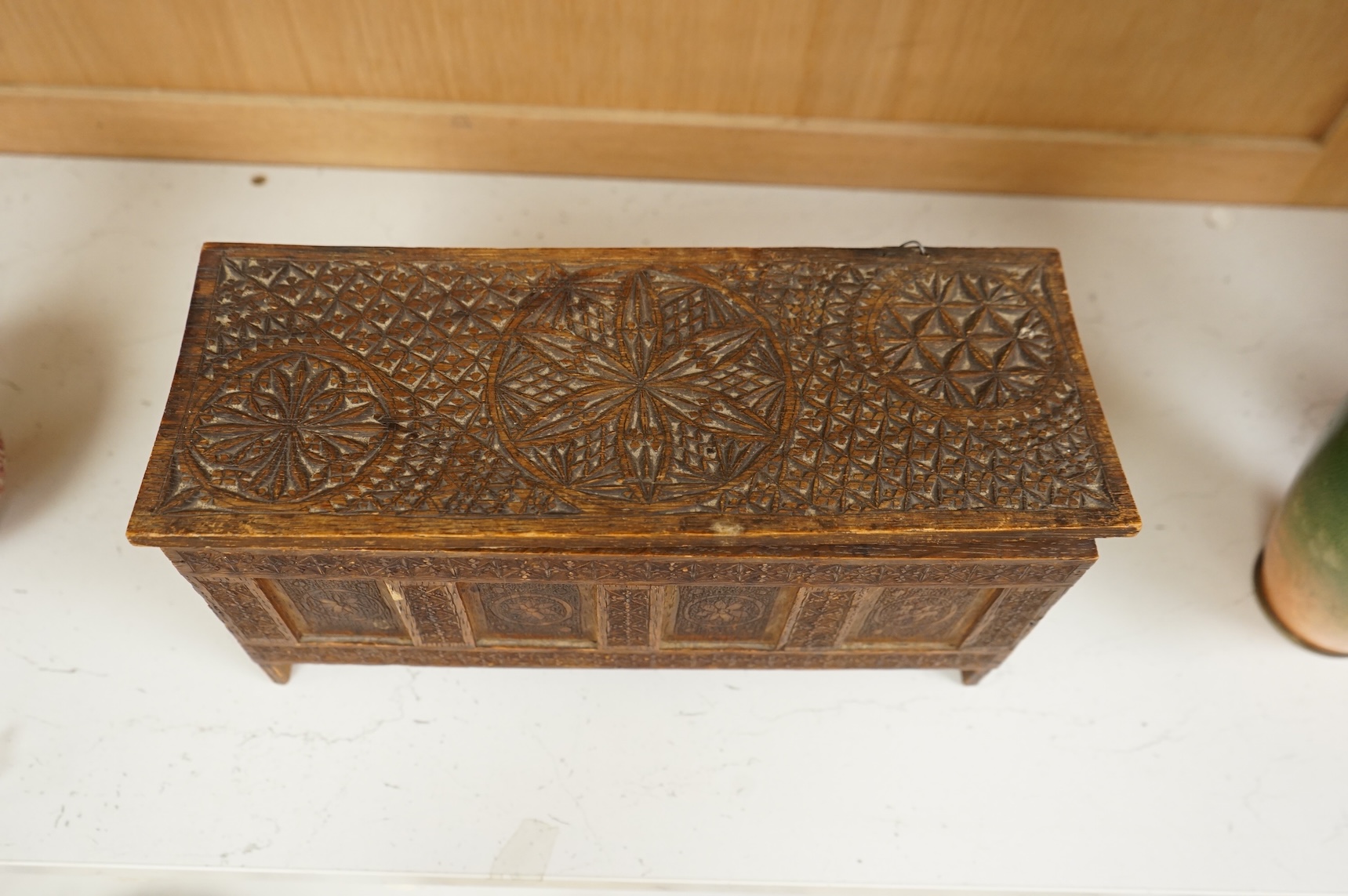 A chip-carved oak miniature coffer with incised date 1901 to the interior, 28cm wide